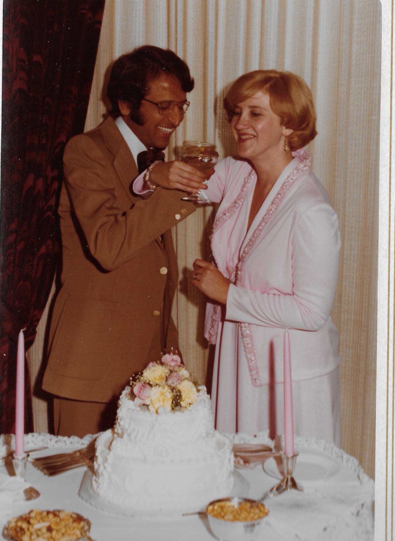 Raising a glass together at the cake table