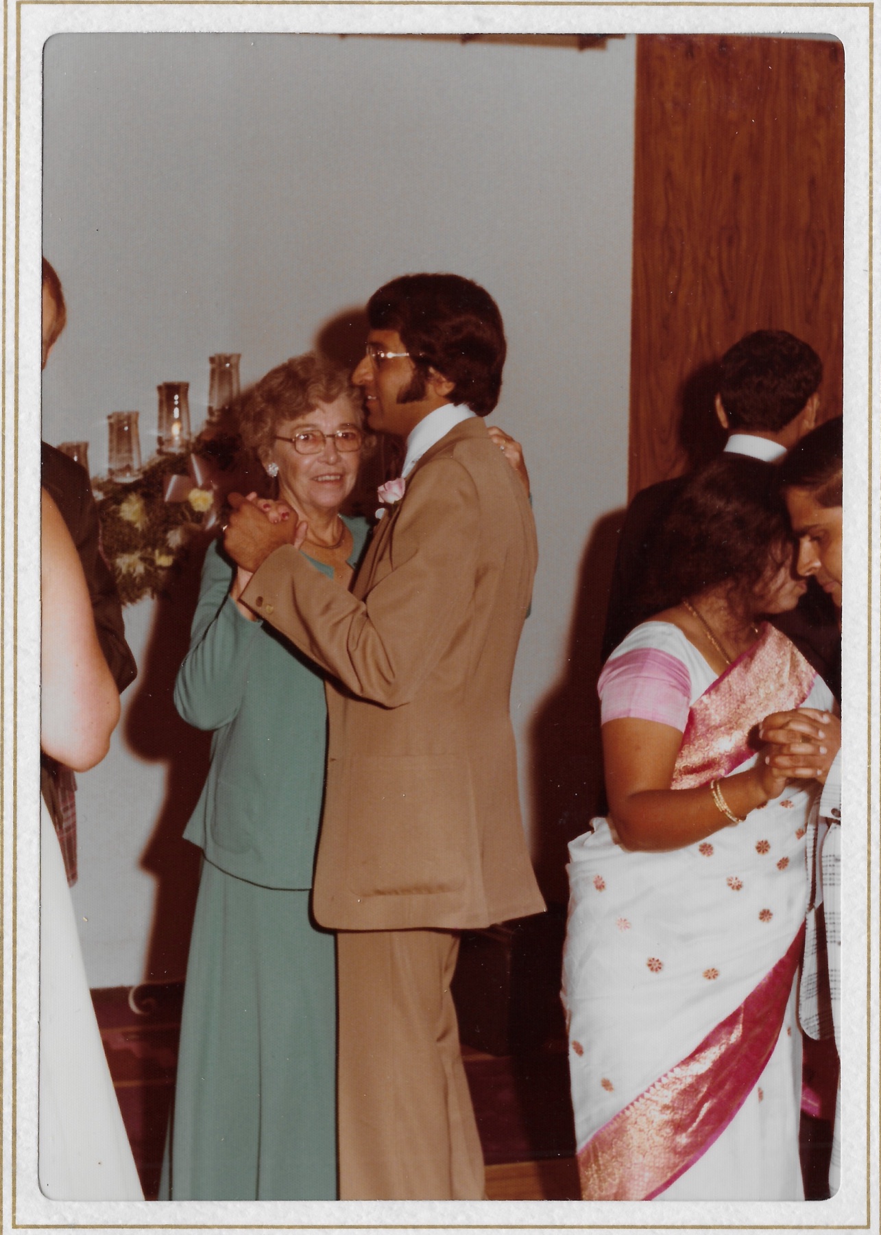 Madhu dancing with Mary Lee’s mother while other guests dance
