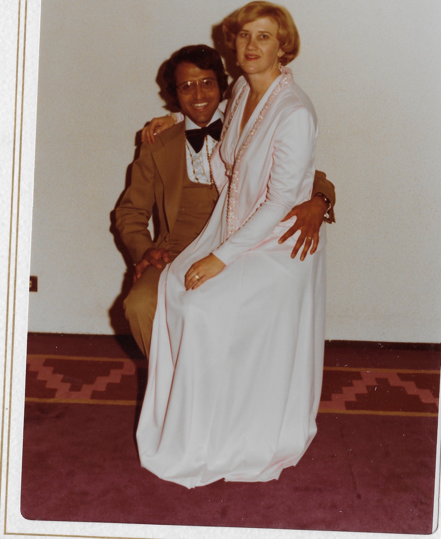 Mary Lee sitting on Madhu’s lap in her wedding dress